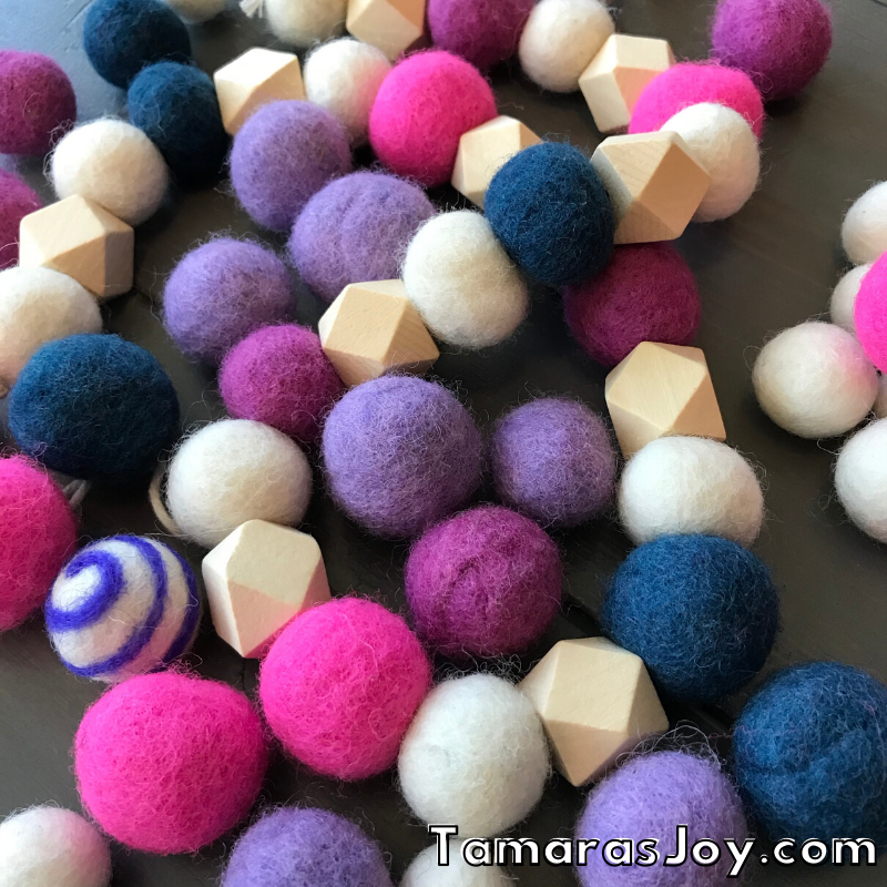 See felted balls among garland