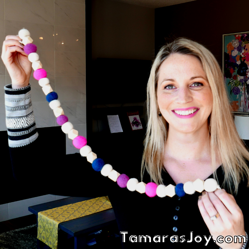 Tamara is showing felted balls on a garland